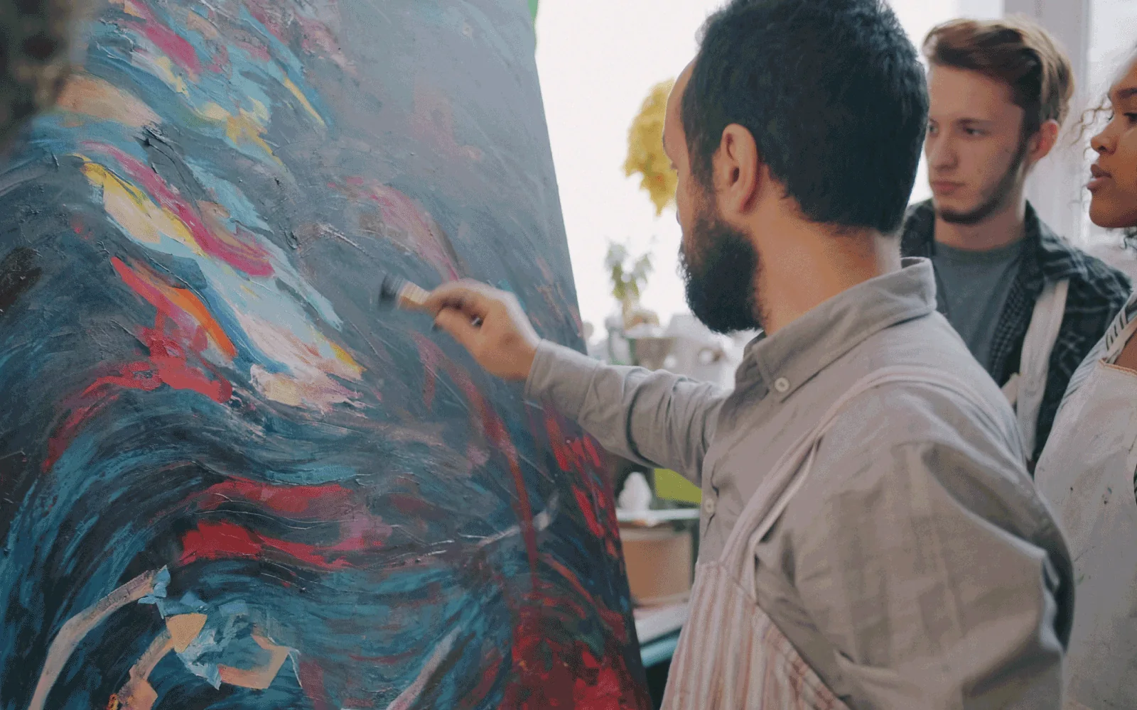 Un pintor frente a su obra, concentrado