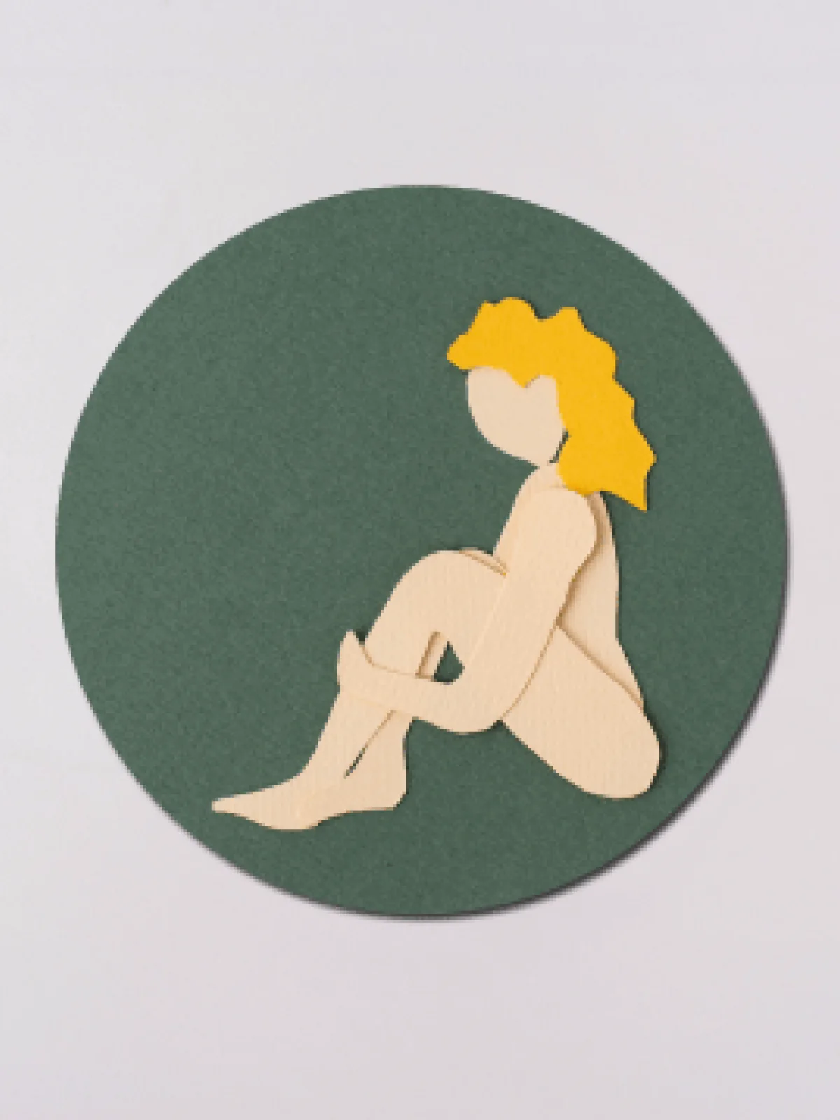 Paper-cut illustration: a person hugging their knees inside a circle, caring for themselves